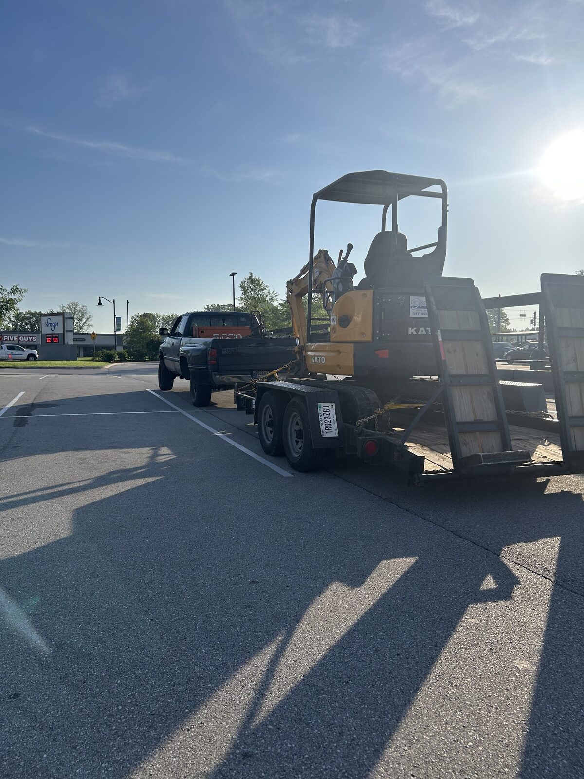 Outlaw Drains and More service truck and equipment trailer on a job